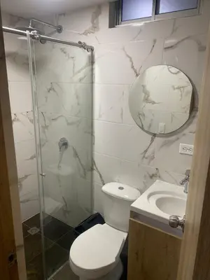 a bathroom with a shower and a toilet and a sink at Hotel Boutique San Joaquin Plaza in Medellín