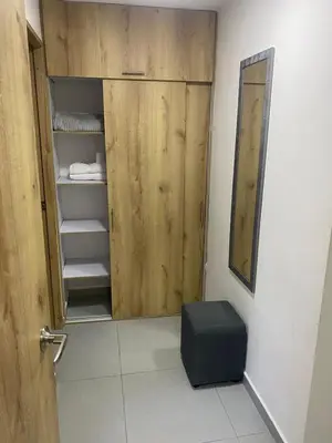 a bathroom with a closet with a wooden door at Hotel Boutique San Joaquin Plaza in Medellín