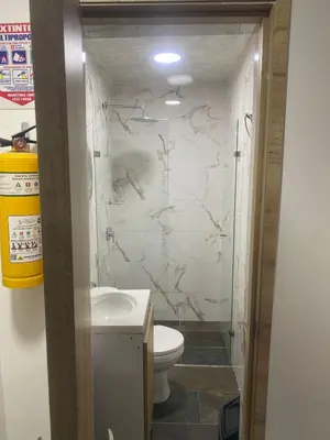 a bathroom with a toilet and a sink at Hotel Boutique San Joaquin Plaza in Medellín