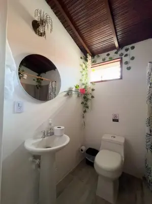 a bathroom with a sink and a toilet and a mirror at Excepcional Casa Privada para Familias y Grupos - Excelente Ubicación in Medellín