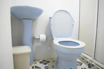 a bathroom with a toilet and a sink at Shaddai restaurante y hospedaje in Puerto Triunfo