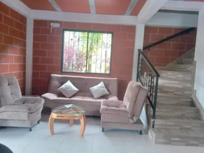 a living room with a couch and two chairs and a table at HOSPEDAJE MARIN in Concepción
