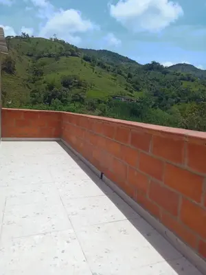 a brick wall with a view of a mountain at HOSPEDAJE MARIN in Concepción