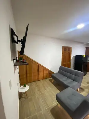 a living room with a couch and a table at Apartahotel Villa Carolina 3 in Jericó
