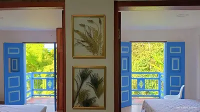a bedroom with two doors and two windows at Apartahotel Villa Carolina 3 in Jericó