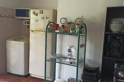 a shelf in a kitchen next to a refrigerator at La Escondida, con acceso al lago in Guatapé