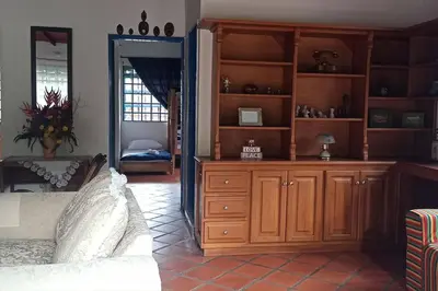 a room with a bedroom with a large wooden cabinet at La Escondida, con acceso al lago in Guatapé