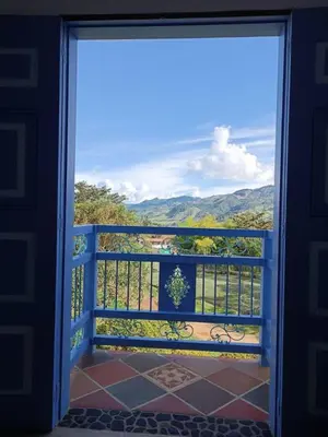 a door to a balcony with a view of the mountains at Apartahotel Villa Carolina 4 in Jericó