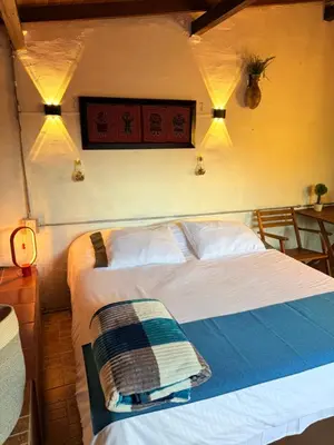 a bedroom with a bed and lights on the wall at Cabaña & glamping para grupos de 4 a 6 personas, cerca al parque y con avistamiento de aves in Jardin