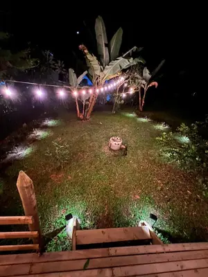 a garden at night with lights on the grass at Cabaña & glamping para grupos de 4 a 6 personas, cerca al parque y con avistamiento de aves in Jardin
