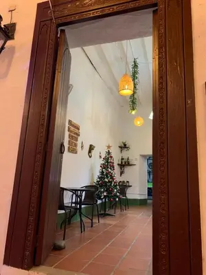 a christmas tree in a room with a table at Casa hotel Dulce Candelaria in Santa Fe de Antioquia