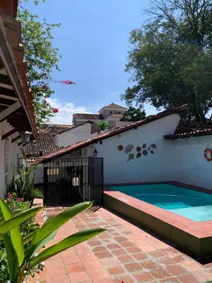 a swimming pool on the side of a house at Casa hotel Dulce Candelaria in Santa Fe de Antioquia