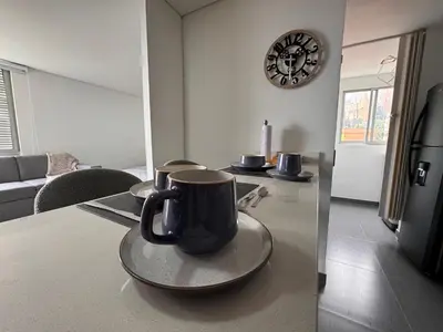 a coffee cup on a plate on a table in a living room at Espectacular apt moderno en el poblado by Hoost in Medellín