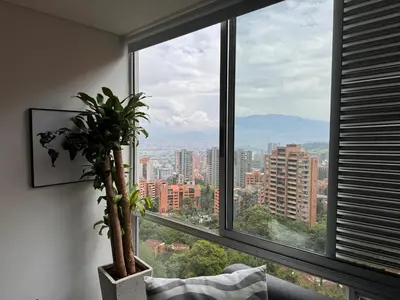 a window with a potted plant in front of it at Espectacular apt moderno en el poblado by Hoost in Medellín