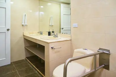 a bathroom with a toilet and a sink and a mirror at Hotel Boutique Fiorentina Medellín in Medellín