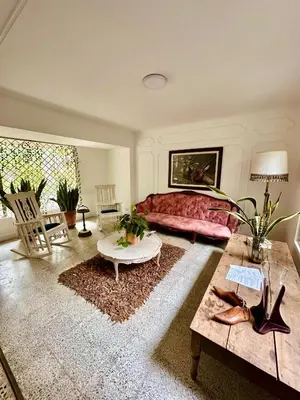 a living room with a bed and a table at Hotel Boutique Fiorentina Medellín in Medellín