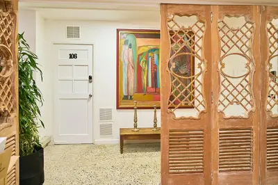 a door in a room with a painting on the wall at Hotel Boutique Fiorentina Medellín in Medellín