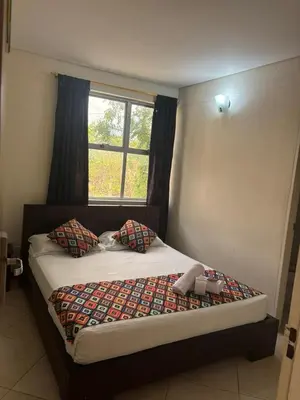 a bed in a room with a window at Hotel Tierra Santa Santa Fe de Antioquia in Santa Fe de Antioquia