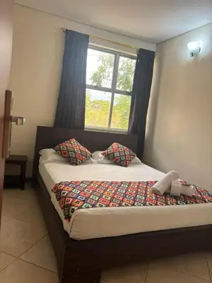 a bed in a room with a window at Hotel Tierra Santa Santa Fe de Antioquia in Santa Fe de Antioquia