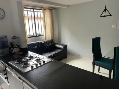 a kitchen and living room with a stove top at no Reservar in Bello