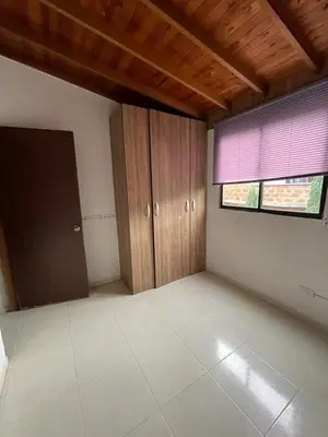 an empty room with a window and wooden cabinets at no Reservar in Bello