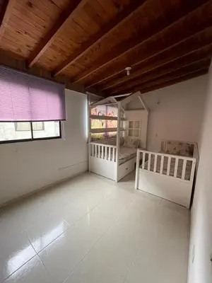 a large room with two beds and a window at no Reservar in Bello