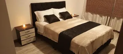 a bedroom with a bed with two pillows on it at Hotel Palo Grande in Manizales