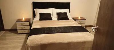 a bedroom with a large bed with two night stands at Hotel Palo Grande in Manizales