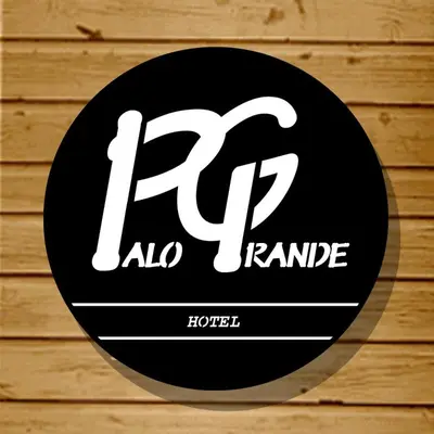 a black and white sign on a wooden wall at Hotel Palo Grande in Manizales