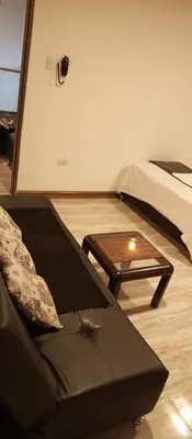 a living room with a couch and a table at Hotel Palo Grande in Manizales