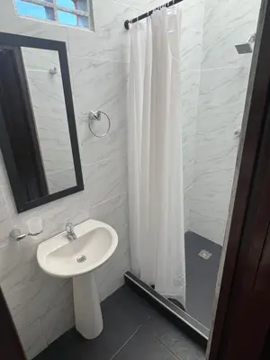 a bathroom with a sink and a shower curtain at Loft Vacacional in Mariquita