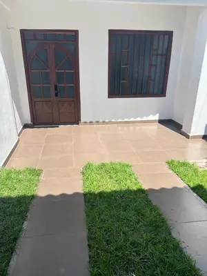 a house with a pair of doors and some grass at Loft Vacacional in Mariquita