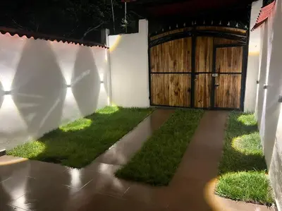 a garage with a door and grass in front of it at Apartamento Vacacional Campestre in Mariquita