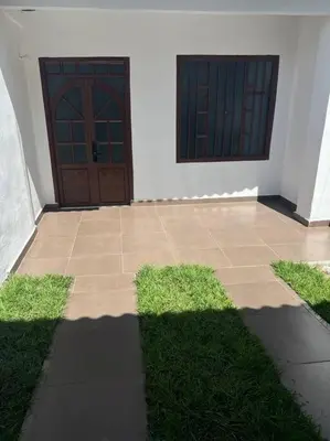 a house with two doors and some grass at Apartamento Vacacional Campestre in Mariquita