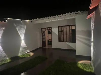 a white house with a view of the ocean at night at Apartamento Vacacional Campestre in Mariquita