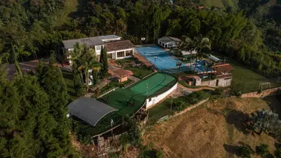 an aerial view of a house with a golf estate at Finca Hotel Los Alpes in Manizales