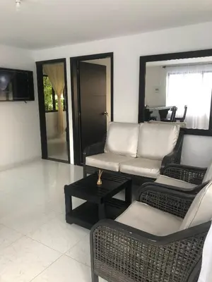 a living room with chairs and a couch and a table at Finca Hotel Los Alpes in Manizales