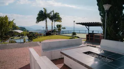 a park with benches and a view of the ocean at Finca Hotel Los Alpes in Manizales