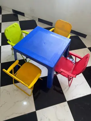 a blue table and four colorful chairs on a checkered floor at La torrecita in Barbosa