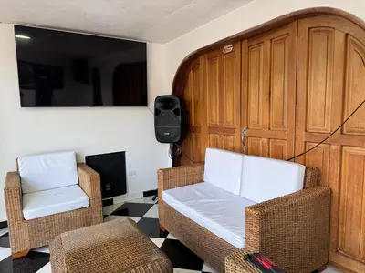two chairs and a couch in a living room at La torrecita in Barbosa