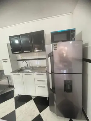 a kitchen with a stainless steel refrigerator and cabinets at La torrecita in Barbosa