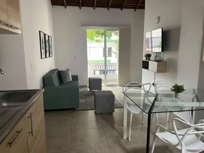 a living room with a glass table and a couch at Apartamento con vista a laureles 401 in Medellín