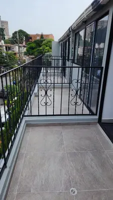 a balcony with a black railing and a sidewalk at Aparta estudios Estadio la 80 in Medellín