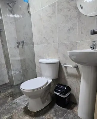 a bathroom with a toilet and a sink at Aparta estudios Estadio la 80 in Medellín