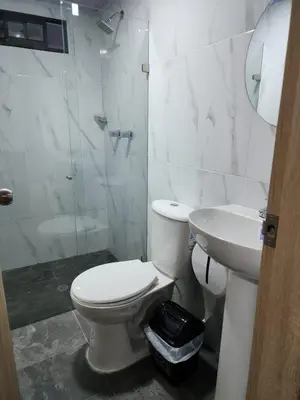 a white bathroom with a toilet and a sink at Aparta estudios Estadio la 80 in Medellín