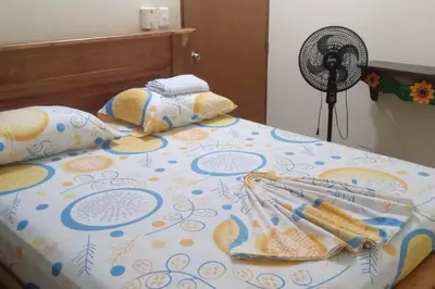 a bed with a bedspread with a fan on it at Casa en Doradal - Antioquia in Doradal
