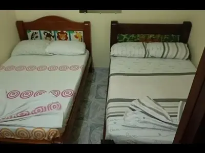two beds sitting next to each other in a room at Casa en Doradal - Antioquia in Doradal