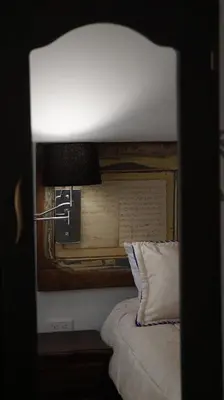 a bedroom with a bed and a lamp on a table at Ayenda Mountain Hostels Manizales in Manizales
