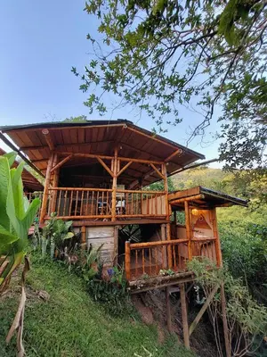 a wooden house on the side of a hill at Aracari Ecolodge in San Rafael