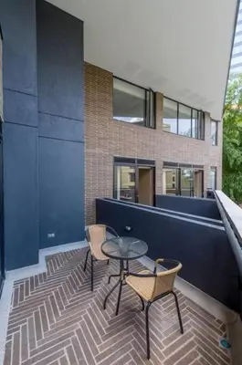 a patio with a table and chairs and a building at El Tesoro Medellín Hab309 by Letoh in Medellín